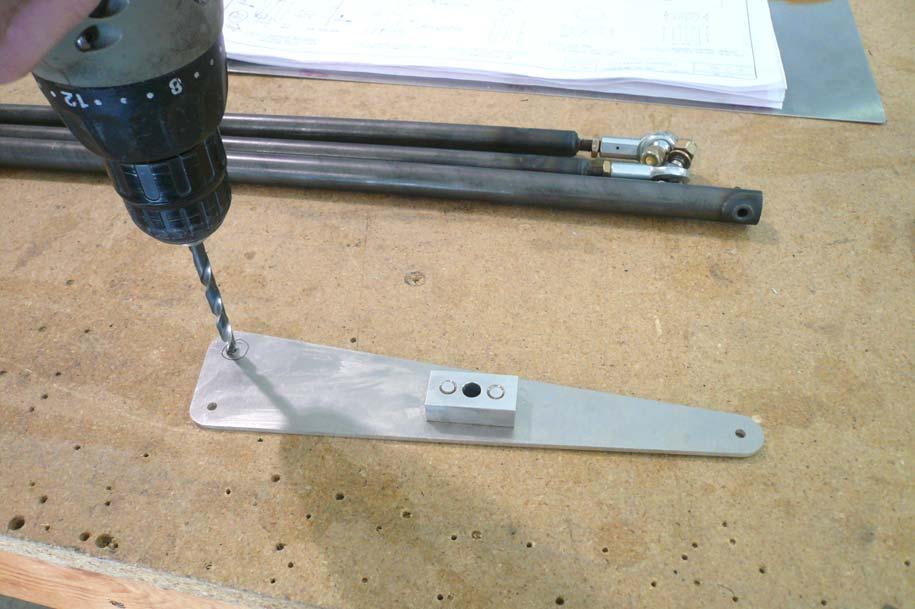 Use a ¼ drill bit to open the bottom forward hole in the Elevator