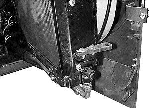 For servicing, the cooler and radiator swing open from the rear door by removing two (2) bolts (Fig. 4.7E). Inspect for dirt build up and flush with compressed air to clean.