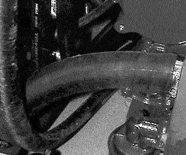 Remove the lower coolant hose from the engine to drain the coolant from the engine block.