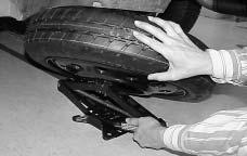 All-Wheel Drive To release the spare tire from the secondary latch, do the following: {CAUTION: 7. Disconnect the wrench from the jack and carefully remove the jack.