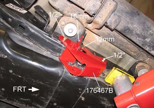 5) Using bracket 176476B as a template, mark the mounting hole locations on the frame and body mount. Mark the relief hole location on the skid plate for the suspension arm bolt. Remove bracket.