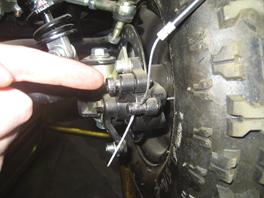 Locate the brake cable coming from the handlebars and place in