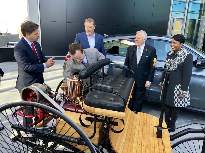 + Dietmar Exler, left, CEO of Mercedes Benz USA, shows off an original 1886 Benz Patent Motor Car, during the grand opening event This just solidifies us as a leader in technology for the future,