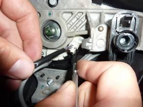 Use fine screwdriver (or similar tool) to depress tab on side of white electrical connectors and detach