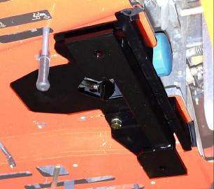 6. Take the 180 degree O-rubber (9) and slide it onto the rear, side edges of the under-seat shield (10), where it contacts the operator platform.