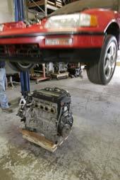 1. Place engine and transmission assembly onto the engine stand and lower the car onto the motor as