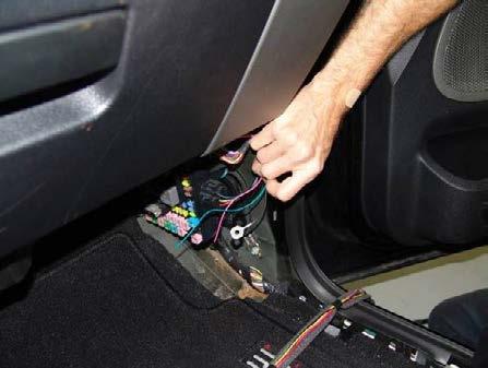 Route the supplied chassis harness green, red, and black wires along the vehicle cross dash harness as shown. Secure using wire ties wherever possible at 2 inch intervals. 34.