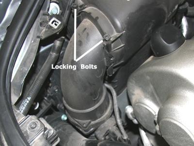 4) Remove the OEM air box cover by rotating the two locking bolts 180 degrees and then pulling them straight up. You will need to do this with a pair of pliers.