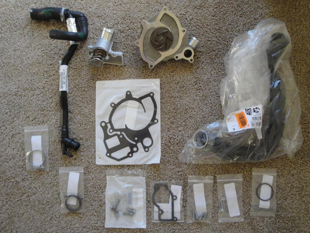 You can see from the top left and going clockwise, the special hose assembly (it comes as a single part), the thermostat in its housing, the water pump with its plastic impeller, the big rubber hose