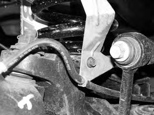 7. Disconnect the brake line bracket from the factory lower coil seat