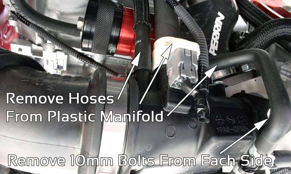 Using long needle nose pliers, pinch large hose clamp securing OEM recirc valve to plastic turbo manifold and slide down and