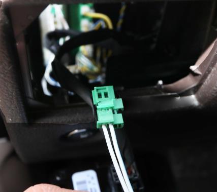 Pull the wire with the zip tie fully out from the open side of the dashboard. 11.