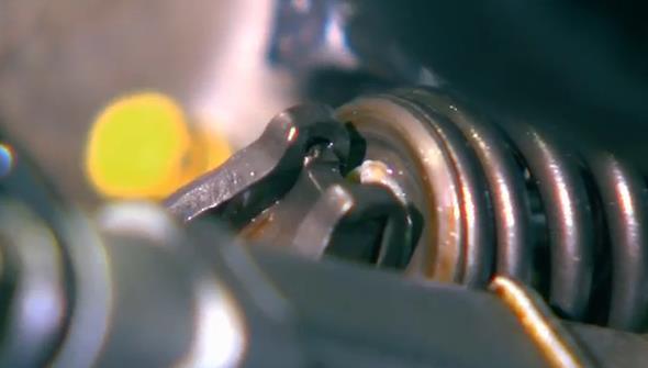 ¼ or 6mm so rocker arm can slide in place. If the spring stays up, simply push it down by hand.