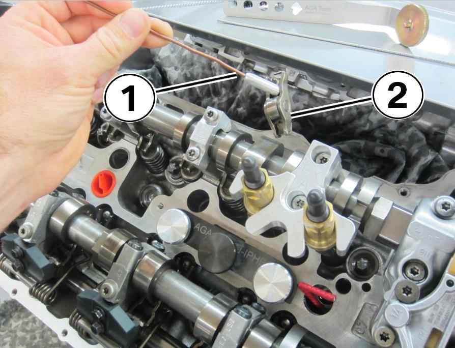 20. Rotate the compression nut (1) counter clockwise with the ratchet (2) until the compression rod compresses the valve Hold the locator handle (3) firmly to keep the compression rod properly