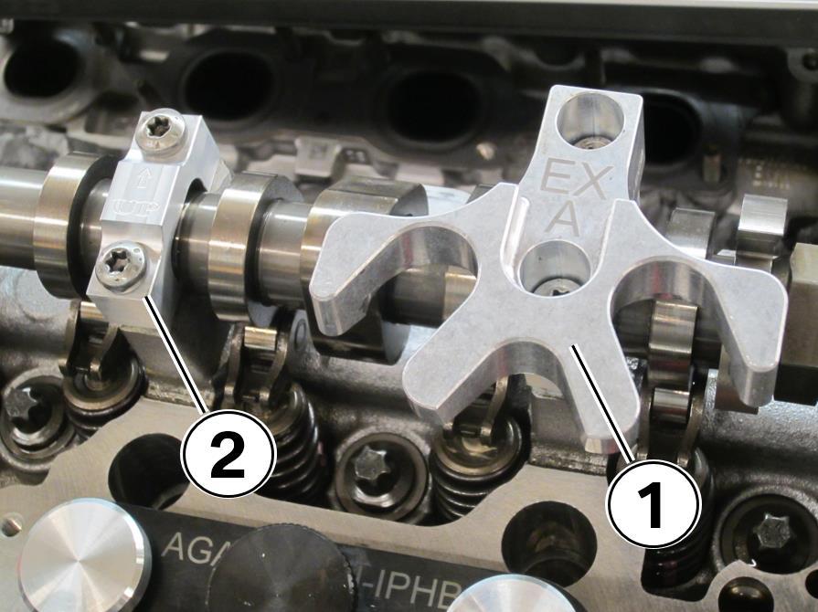 Check the alignment of the rocker arms (1) on the valve stems and lifters when complete. 42. The exhaust valve seals are complete on this cylinder. Do not reinstall the HDP housing yet.