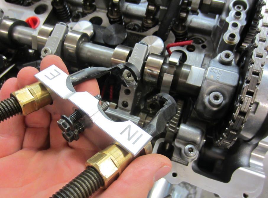 59. Remove the compression bracket (1), compression rods (2) and VVT spring block screws (3).