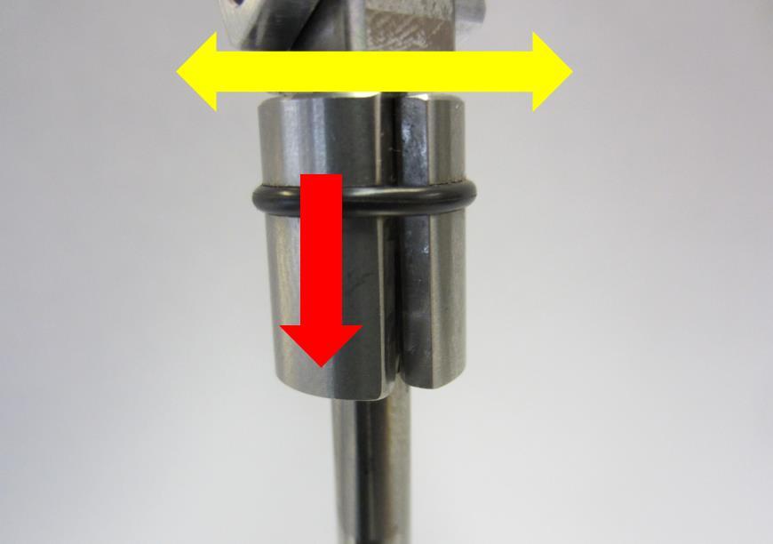 Gently place the keeper installation tool (1) on top of the valve (2) until the machined hole in the tool