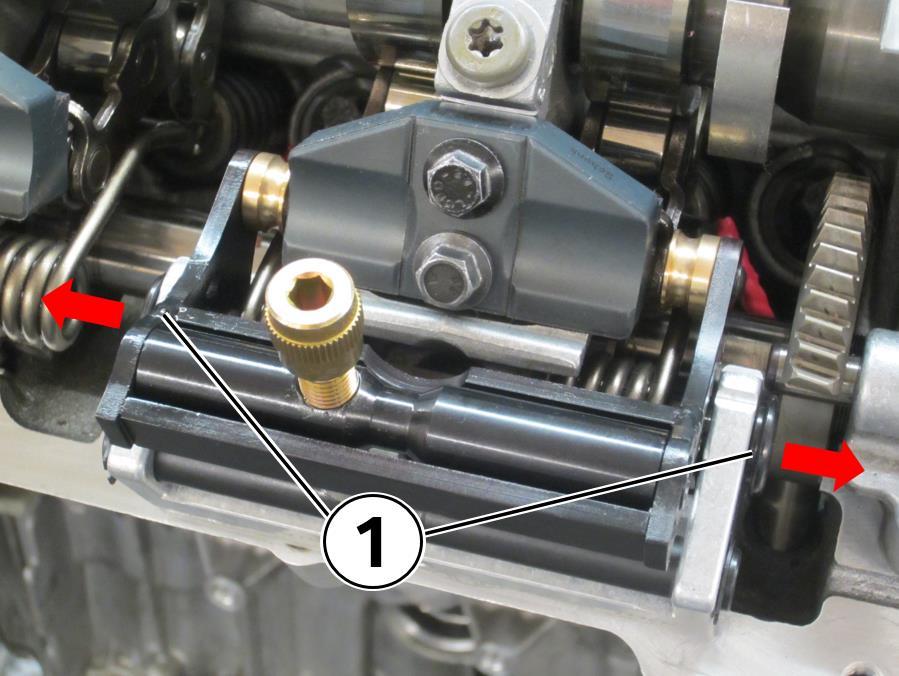 88. Pull the VVT spring retainers (1) outward in the direction of the arrows. Remove the tool from the engine. 89.