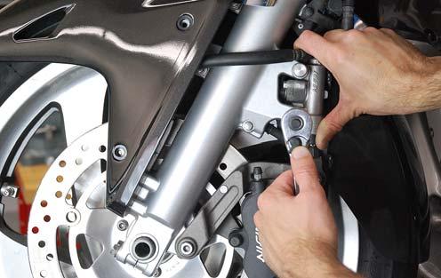 8. While firmly holding the secondary master cylinder in this position, tighten the lower cylinder mounting bolt as shown.