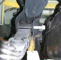 Note: These bolts are located behind the fuel door. The fuel extension clamp located on the outside of the driver side frame rail must also be disconnected. (See Photo # 21) Photo # 21 8.