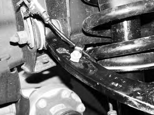 Attach the ABS line to the upper control arm with the original brake line mounting bolt and provided wire clamp.