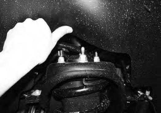 Strike the knuckle near the upper and lower ball joints to dislodge them from the knuckle. Remove the upper ball joint nut and lower the lower control arm down.