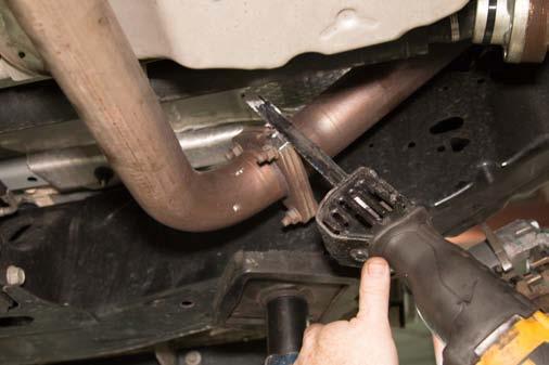 Using a reciprocating saw, cut the corner off of the exhaust flange to clear