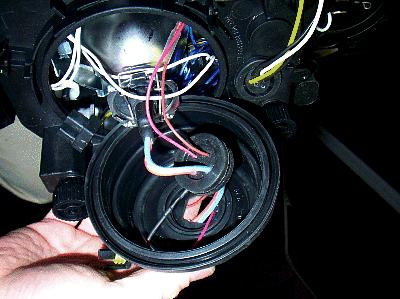 The lights come with some rubber boots. You need to cut a hole in them so that you can pull through the wiring harness.