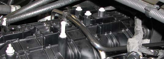 Then unravel the retainer bracket from the engine harness to remove the