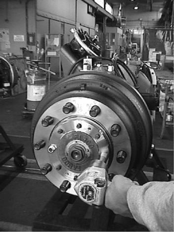 2 WHEEL BEARING ADJUSTMENT 1. The front of the vehicle should be raised, properly supported, and the front wheels removed from the axle. 2.