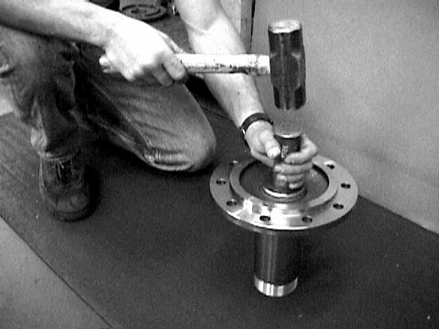 11. Install the dust shield/brake spider assembly onto the spindle yoke studs with the large hole positioned to receive the air chamber mounting bracket.