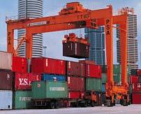 The RTG straddles the stacks of containers and has room for a heavy-duty truck/yard tractor to pull under and move containers between the stacks and vehicles.