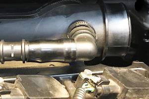 Naturally the plastic will form-fit to the barb-to-barb reducer. No clamp is necessary for the connection point. After cooling, reinstall the short OEM rubber hose to the valve cover barb.
