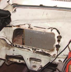 The battery tray is bolted to the radiator core support and inner fender.