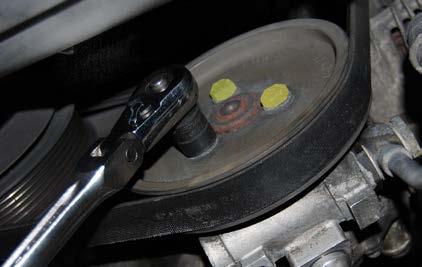 TECH TIP Leaving the belt on for this step will help hold the pulley to keep it from turning while loosening the bolts.