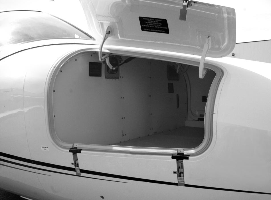 The nose storage compartment holds up to 20-cubic feet (320- pounds) of baggage. It has two swing-up doors (left and right). Each door has a mechanical lock.