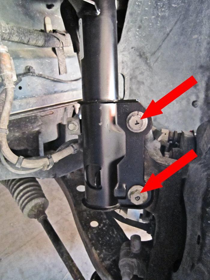 Slide both strut-to-spindle bolts through the lower strut clevis and spindle (left picture below). 39.