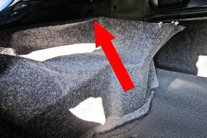 4. Inside the vehicle s trunk, pull back the upper edge of the trunk wall lining to expose the top of