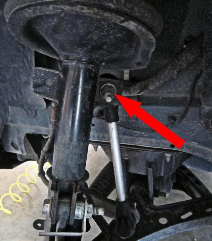 8. Using a panel puller or needle-nose pliers, remove the plastic ABS sensor wire retaining