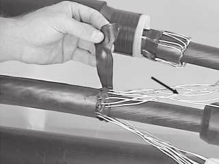 3 For Concentric Neutral, Jacketed Concentric Neutral and Flat Strap Neutral Cables: vinyl tape Form the shield sleeve across the splice body.