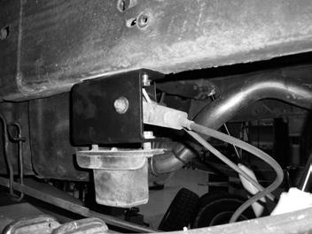 On the driver s side, attach the factory brake line bracket to the hole in the new bump stop extension with the