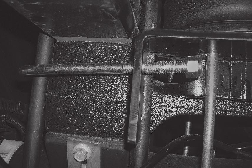 On the driver s side (left), the long carriage bolt in the lower bracket main plate should be located between the hard brake line and axle (Fig. D.20).