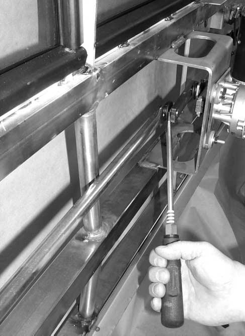 F05600 Figure 5 : LH wiper tie bar inner knuckle joint (step shown on test stand) 7) With a 10 mm box wrench and a socket and ratchet undo the bolt and nut securing the clamp to the