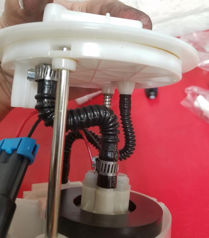 Reconnect the fuel pump harness to the bottom of the lid, routing the