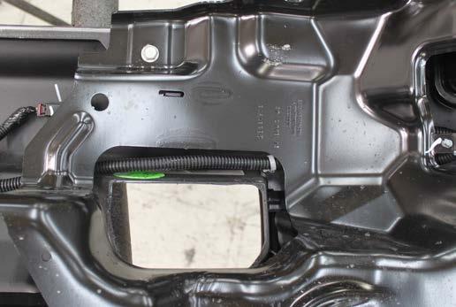 All Silverado/Sierra Models: Trim out the tow hook pocket opening to fit around the