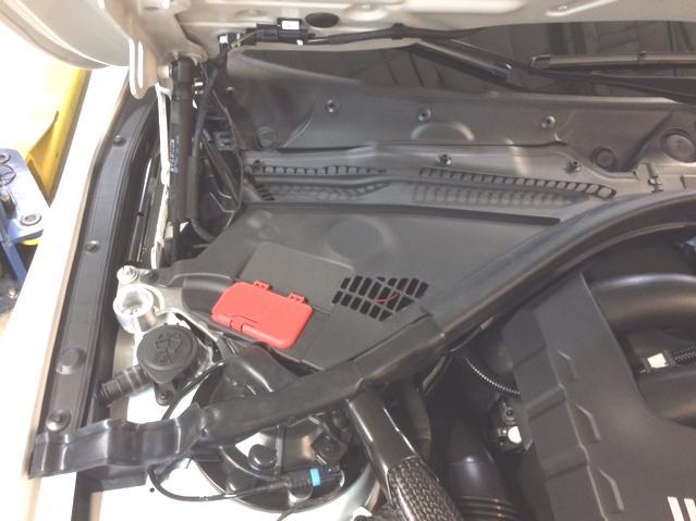 temporarily severed. 2. Open hood and remove the (2) cover panels that cover the OEM carbon brace.