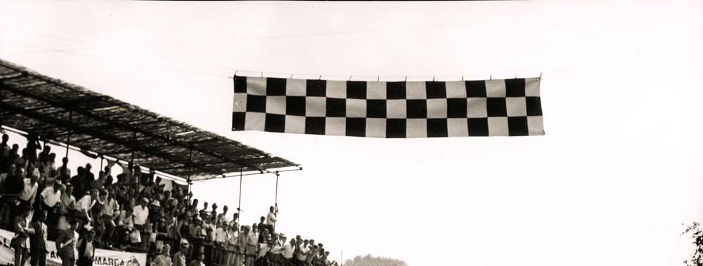 Above: Great moment - the chequered flag falls on the Bulgari/Grana Porsche 904 GTS 080 as it wins the 1964 Mugello road race in rural Italy.