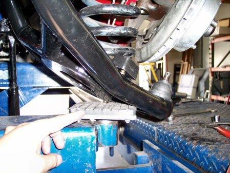 This step will be easy with aftermarket lowering springs and difficult with OEM stock springs.