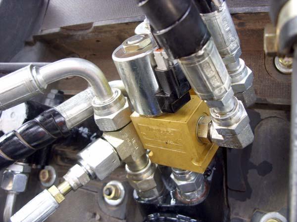 The solenoids are installed between the AutoSteer Tee connections and the Orbitrol on the right and left steer lines.