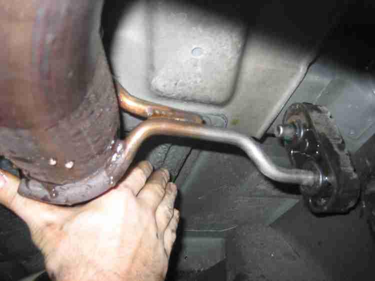 L) 7) Use a 15mm socket and ratchet to remove the flange nuts at the flange connection of the head-pipe.